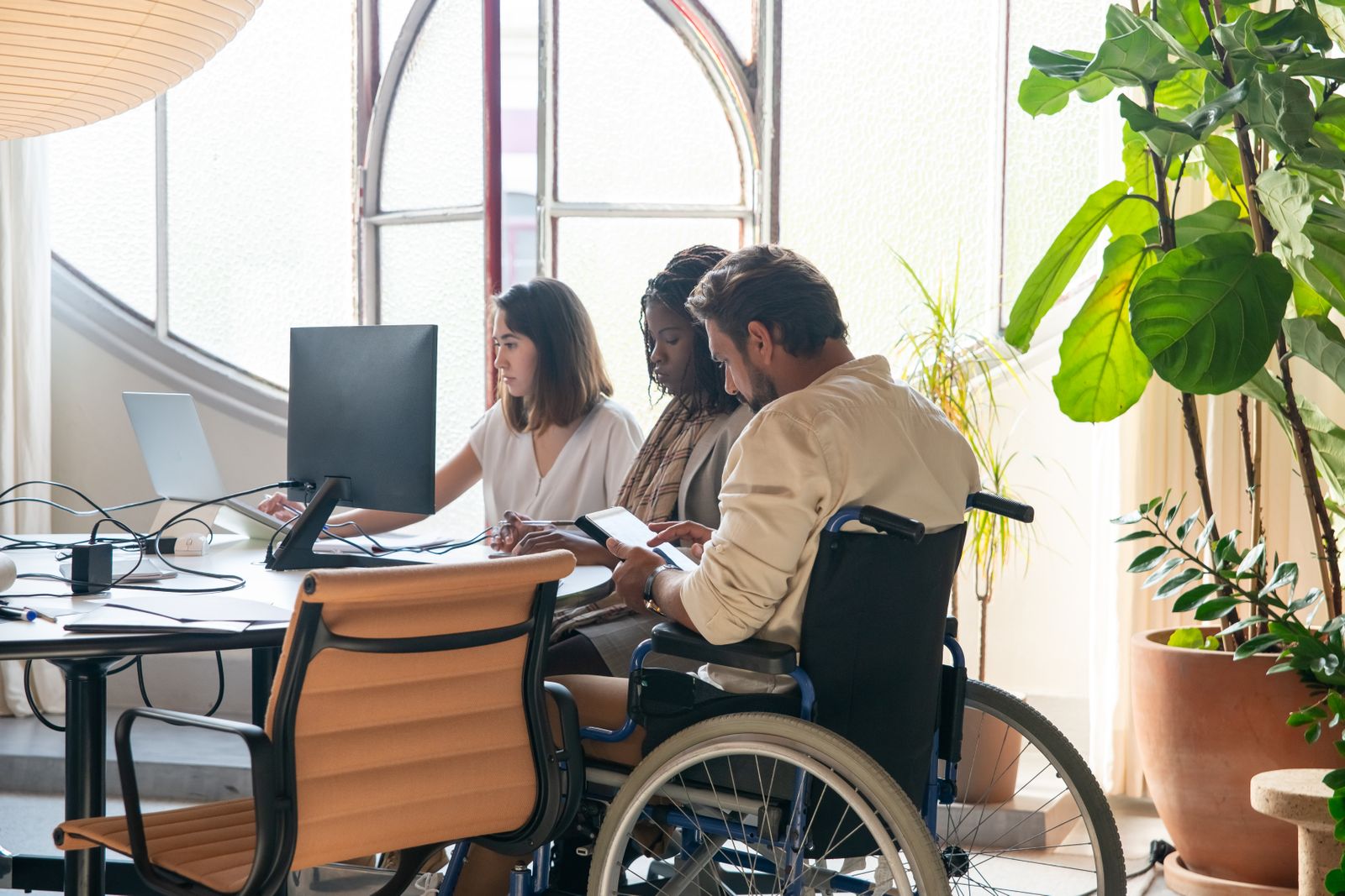 A global technology team collaborating around a laptop